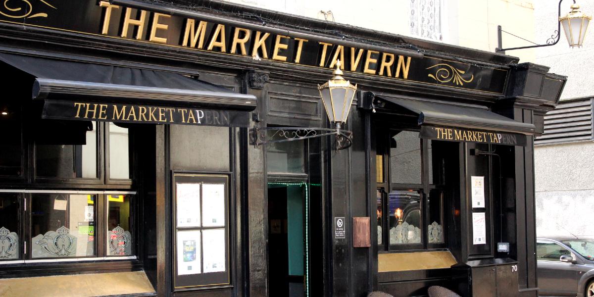 Main image: Exterior of The Market Tavern Preston. Black and gold exterior of The Market Tavern Preston.